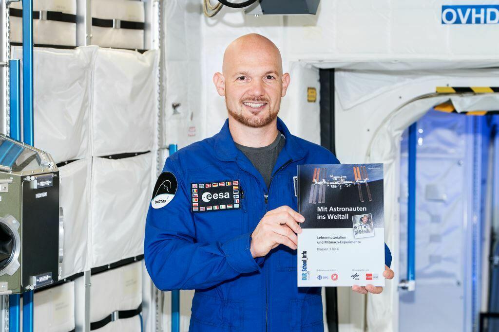 Bild von Alexander Gerst mit Schulheft "Mit Astronauten ins Weltall"