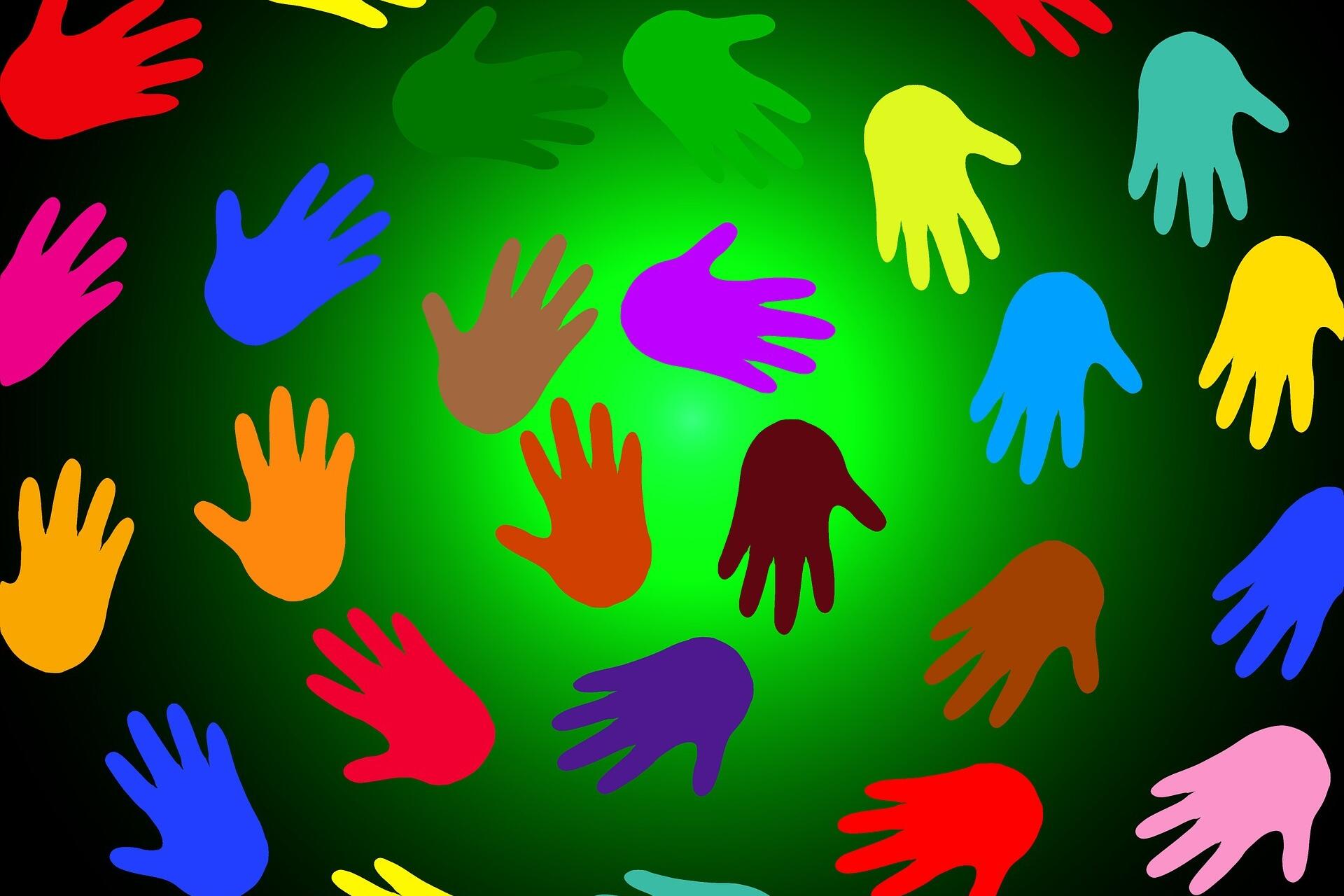Bunte Handabdrücke vor grünem Hintergrund